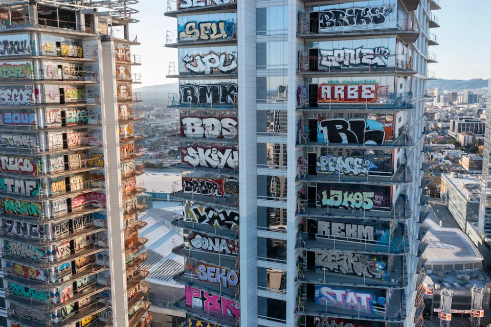 Aerial view of Oceanwide Plaza skyscrapers covered with graffiti tags.